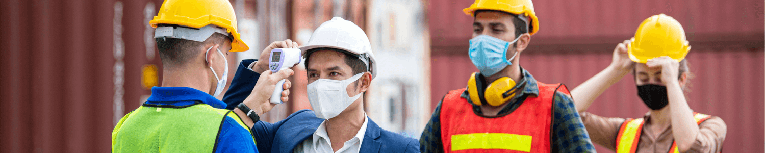 Emerging risk - constructions workers wearing face masks having their temperature checked before starting work